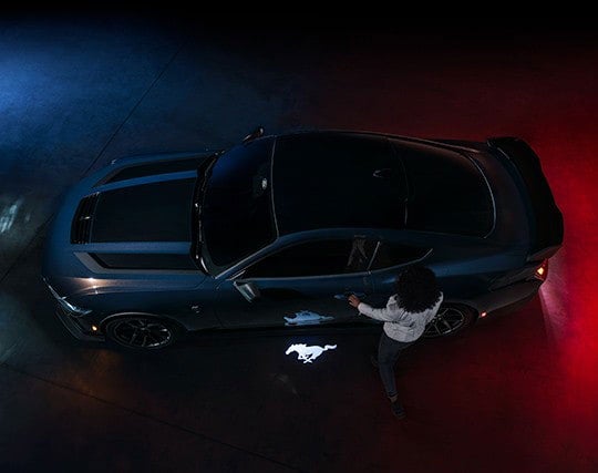 2024 Ford Mustang® Dark Horse™ model with a driver approaching the vehicle | Bob Poynter Ford, Inc. in Seymour IN