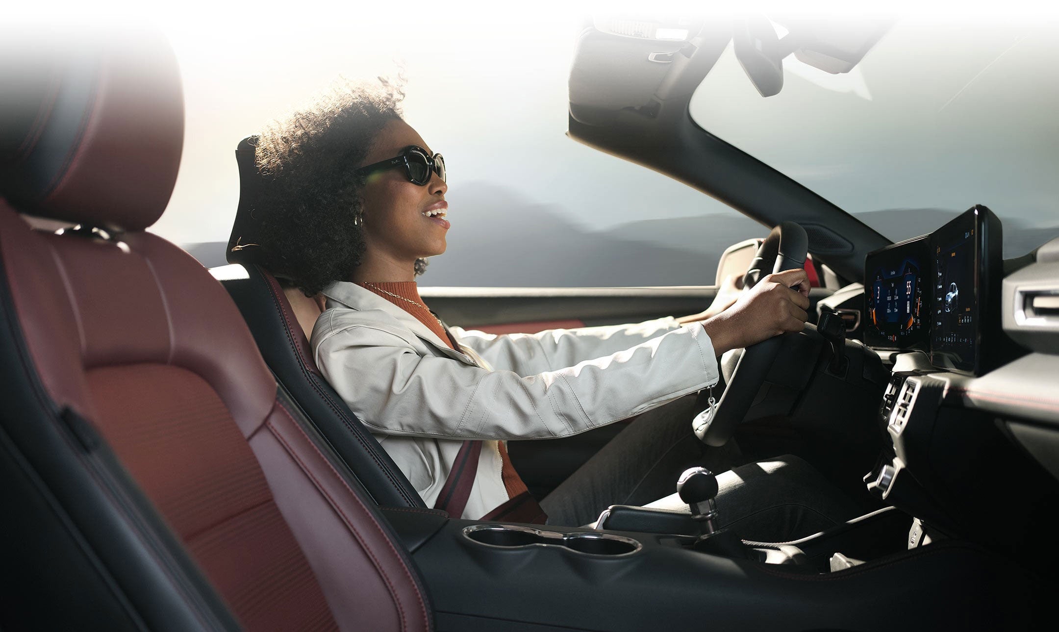 Person sitting in the driver’s seat of a 2024 Ford Mustang® convertible | Bob Poynter Ford, Inc. in Seymour IN