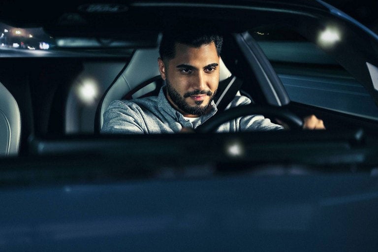 Person sitting in the driver’s seat of a parked 2024 Ford Mustang® coupe | Bob Poynter Ford, Inc. in Seymour IN