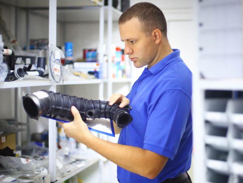 image of a man holding a car part